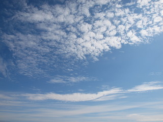 Naklejka na ściany i meble Blue sky with white clouds background. Sunny