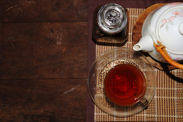 Green tea cups and glass jars with dry green tea