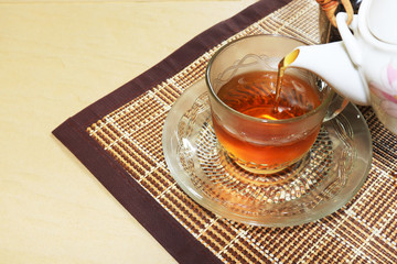 Green tea cups and glass jars with dry green tea