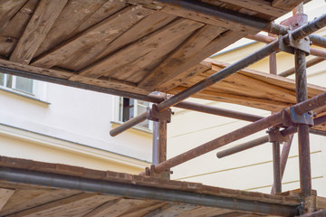 Close-up of old scaffolding with rusty beams and wooden floor