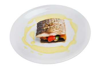 Grilled fish with vegetable on a plate on a white isolated background