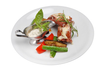 Steak with vegetables and white sauce on white plate on white isolated background