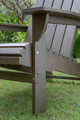 The detail of grey wood rocking chair in backyard..