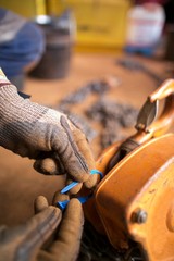 Rigger hand inspecting safety tagging fastening industrial chain block lifting equipment at construction site, Perth, Australia  