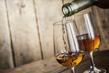 Sherry being poured into an elegant glass