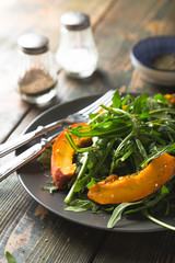Autumn salad of fresh arugula and baked pumpkin