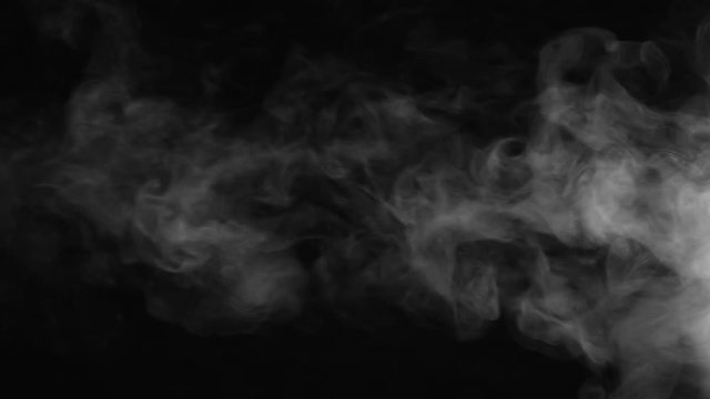 Steam Swirls and Moves Left. Horizontally moving the  white vapor stream slowly disappears reaching the opposite side on a black background. Filmed at a speed of 120fps