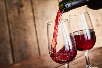 Fruity red Shiraz wine being poured into glasses