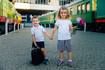 Children's travel, travel with a child. The child goes to sea, on vacation. Boy met girl from the...