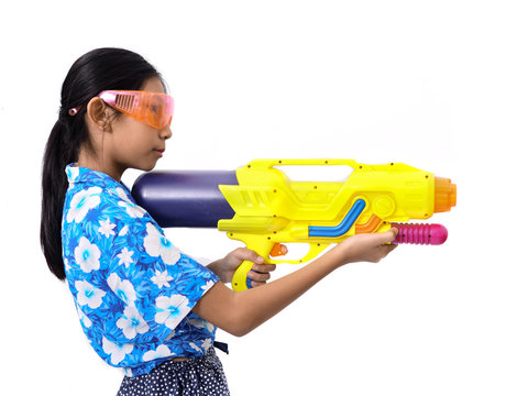 Young Asian girl with water gun on white background, Songkran Festival concept.