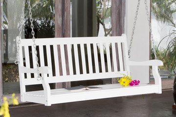 The white wood swing in the backyard.