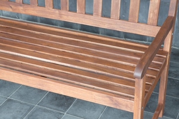 The detail of brown wood bench in the backyard.