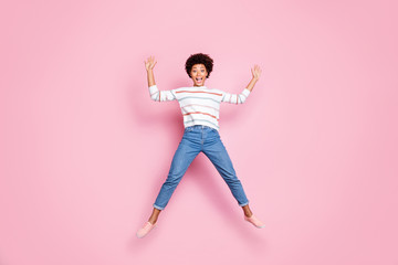 Full length body size photo of ecstatic overjoyed beautiful attractive cute nice black lady rejoicing with jumping up wearing jeans denim shaping star in striped sweater isolated pastel color
