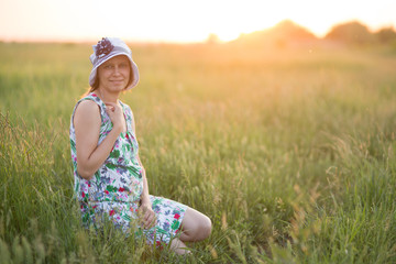 Pregnant woman in the meadow,