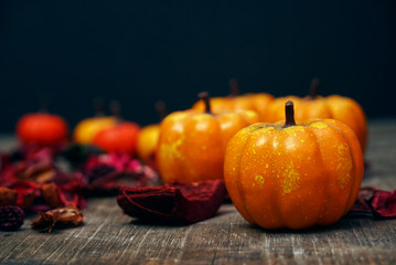 Pumpkins decorate with red dry leaf with wood background have space for copy , halloweeb concept.