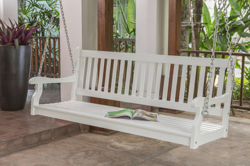 The white wood swing in the backyard.