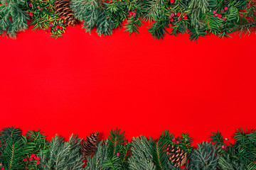 Frame Christmas tree branches on red background.