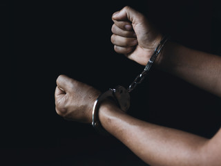 prisoner concept,Handcuffed hands of a prisoner in prison, Male prisoners were severely strained in the dark prison, violence,