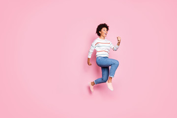 Fototapeta na wymiar Full length body size photo of cute charming cheerful astonished shocked black youngster running jumping towards sales with emotions on face jeans denim sweater striped isolated pastel color