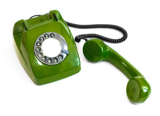 Old green rotary telephone on a white background