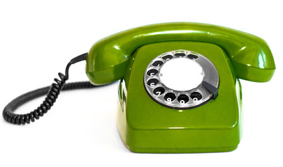 Old green rotary telephone on a white background