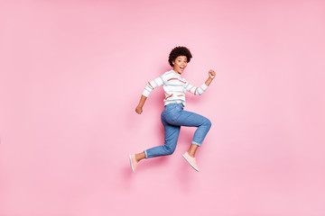 Full length body size photo of cute excited ecstatic sweet cute woman running jumping fast quickly with emotional face expression isolated over pink pastel color background