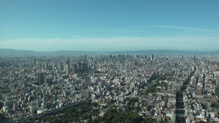 OSAKA, JAPAN - CIRCA SEPTEMBER 2019 : Aerial high angle view of CITYSCAPE of OSAKA in daytime. Osaka is the second largest metropolitan area in Japan. Zoom in shot.