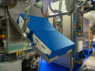 Conveyor line in the production. Enterprise automation. Production without human intervention. Packaging line. Marking boxes with products.The machine marks the packaging. Application of data on boxes