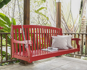 The red wood swing in the backyard.