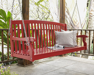 The red wood swing in the backyard.