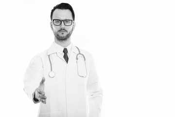 Fototapeta premium Studio shot of young man doctor giving handshake