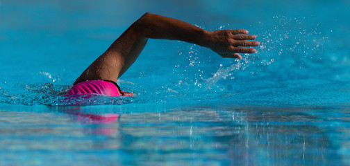Swim competition swimmer athlete doing crawl stroke in swimming pool