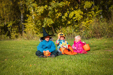 kids in halloween costume play in nature, trick or treating