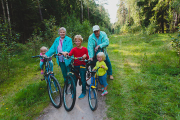Fototapeta premium active senior couple with kids riding bikes in nature