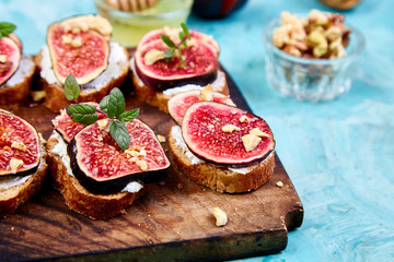 Bruschetta  or ctostini with cottage cheese, figs and honey. Sandwich with figs and goat cheese..
