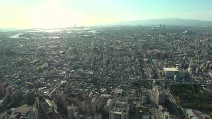 OSAKA, JAPAN - CIRCA SEPTEMBER 2019 : Aerial high angle view of CITYSCAPE of OSAKA in early evening sunset time. Osaka is the second largest metropolitan area in Japan.