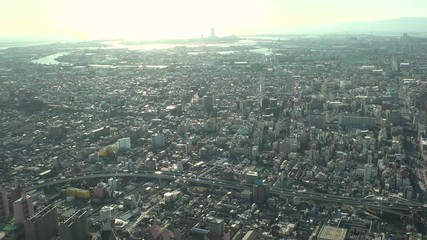 OSAKA, JAPAN - CIRCA SEPTEMBER 2019 : Aerial high angle view of CITYSCAPE of OSAKA in early evening sunset time. Osaka is the second largest metropolitan area in Japan.