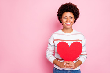 Photo of cheerful cute nice sweet charming girl holding big red heart with her hands wearing...
