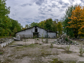 autumn landscape with demolition of the building, destroyed building, surrounded by colorful trees