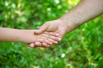 hands of young child and old senior