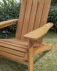 The detail of wood beach chair in the backyard.