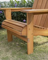 The detail of wood beach chair in the backyard.