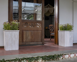 The wood flowerpot with flower in the backyard.