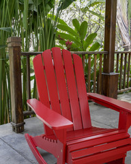 The detail of red wood rocky chair in the backyard. 