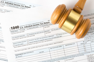 Fototapeta na wymiar Closeup image of american 1040 Individual Income Tax return form with judge gavel.