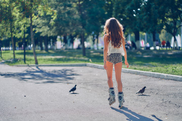 young woman rollerblading in the park