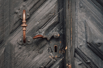 Old decorated wooden door with handle and lock