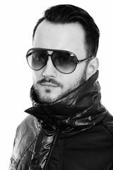 Face of cool young man wearing sunglasses with collar up