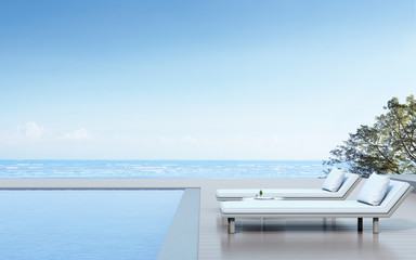 Fototapeta na wymiar View of daybed with side table and wood terrace on sea view background,Blue pool. 3D rendering