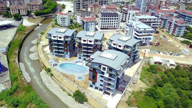 New hotel complex with swimming pool. Clip. Top view of beautiful hotels with modern architecture and outdoor swimming pool in resort town